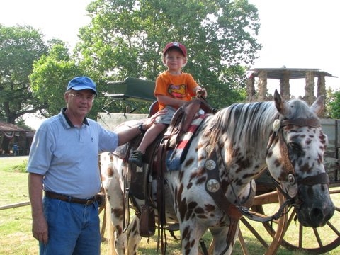Bruce Arnold and his 3-year old grandson Max taking a ride on Chester.